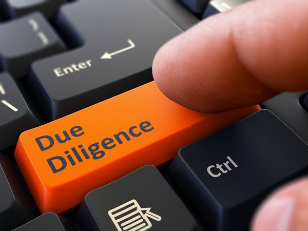 Closeup of a keyboard with a finger pressing an orange colored key labeled 