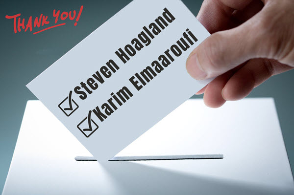 A hand inserting a ballot into a ballot box which has checkmarks next to Steven Hoagland and Karim Elmaaroufi, with thank you in the corner.