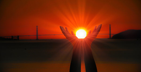 A Gateview sunset viewing the Golden Gate Bridge and hands embracing the sun.