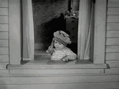 Gif showing Spanky of The Little Rascals gleefully throwing money out of a bedroom window.
