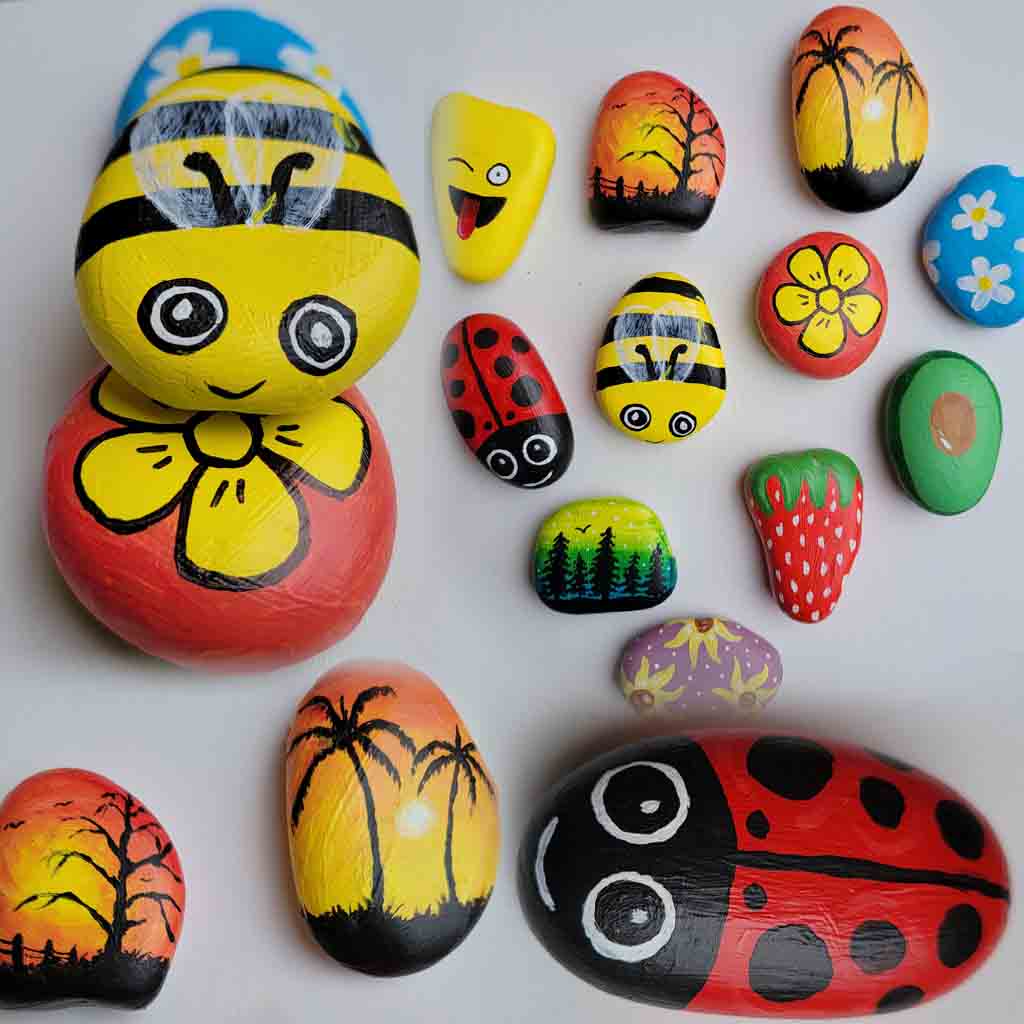 Painted rocks with colorful designs: bees, ladybugs, flowers, sunset scenes, and abstract patterns.